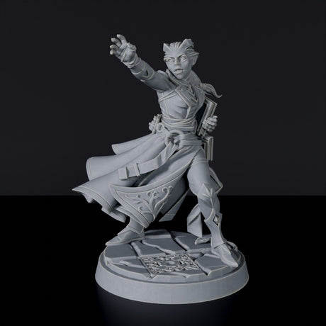 Fantasy miniature of Tiefling Female Wizard with tome and cloak for tabletop role-playing games