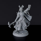 Miniature of Tiefling Female Cleric with pick, helmet and cloak for fantasy tabletop role-playing games