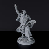 Miniature of Constructed Male Cleric with tome, cloak and hammer for fantasy tabletop role-playing games